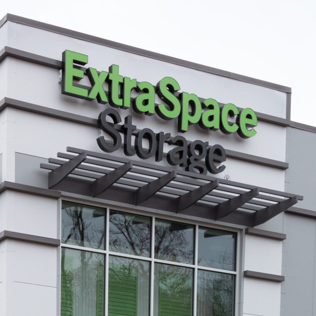 Extra Space Storage sign displayed on a building front, showcasing storage services offered at the location.